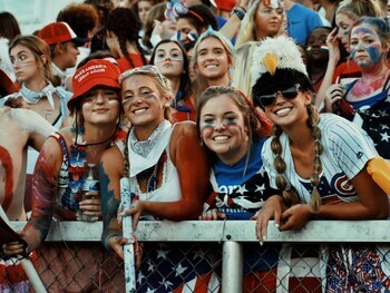 Picture of students behind a fence smiling