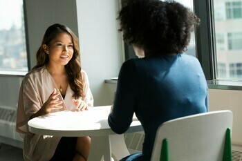 Picture of two people sitting at a desk