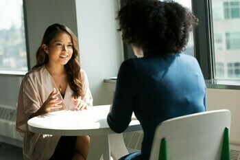 Picture of two people sitting at a desk